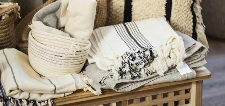Linen throws folded on a crate