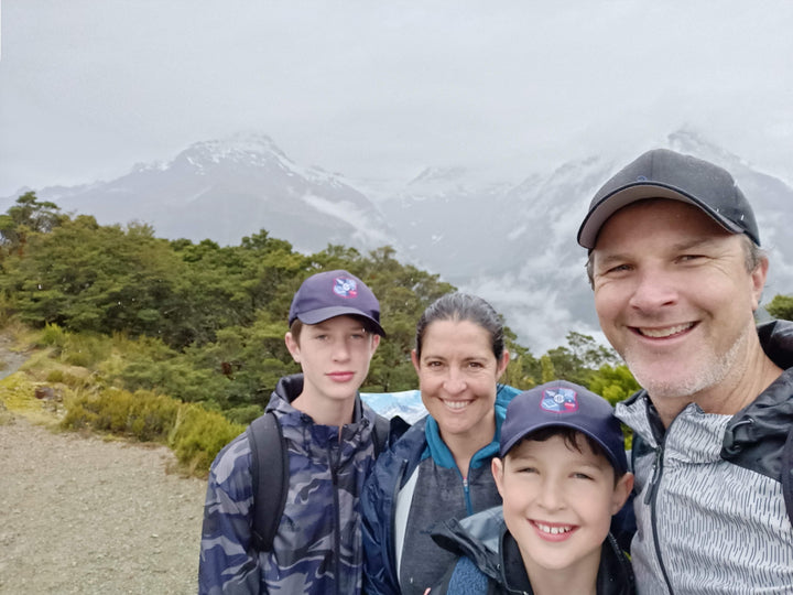 Kind Face founder Chris Larcombe with his wife and two sons hiking in the mountains