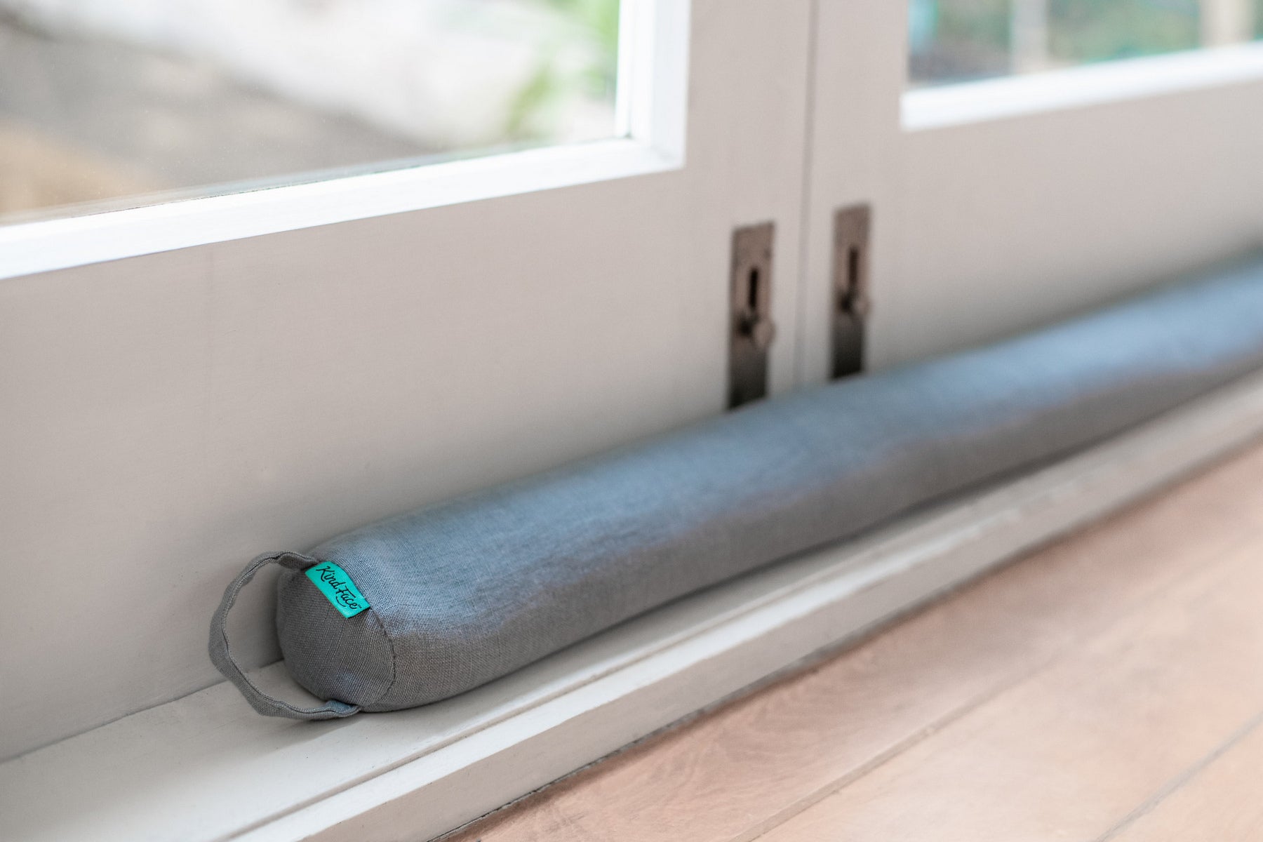 Kind Face Linen Draught Stopper in Copenhagen colour against doors