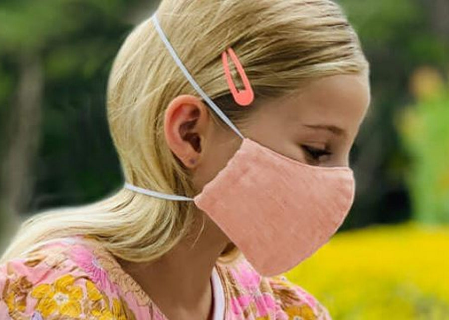 Girl Wearing a Kind Face Reusable Linen Face Mask in Soft Pink Colour