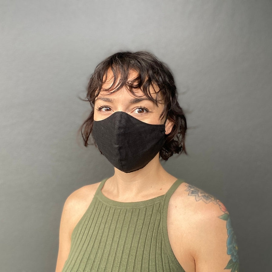 Woman Wearing a Kind Face Reusable Linen Face Mask in Black Colour