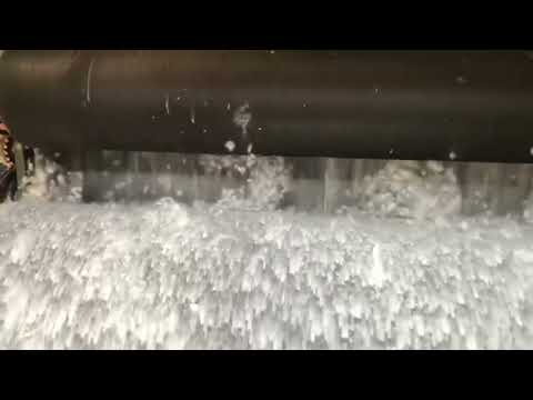 Slowmotion Footage of Kind Face Cloud Wool Being Processed Through a Machine
